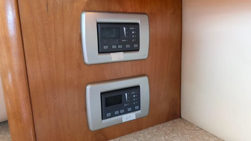 Slide: The Image of Control panels on 2004 Meridian 408 Motor Yacht's wooden interior. - 34