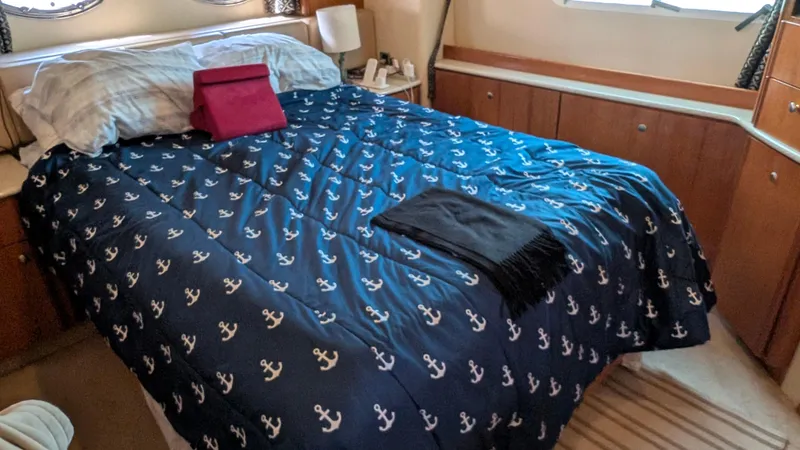 Slide: The Image of Cozy bedroom in 2004 Meridian 408 Motor Yacht with nautical-themed bedding. - 36