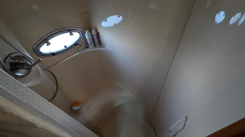 Slide: The Image of Shower area in 2004 Meridian 408 Motor Yacht with porthole and toiletries. - 38