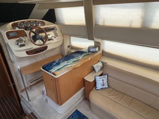 Slide: The Image of 2004 Meridian 408 Motor Yacht interior with helm, leather seating, and nautical decor. - 42