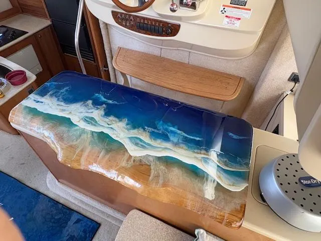 Slide: The Image of 2004 Meridian 408 Motor Yacht interior with ocean-themed resin art table. - 43
