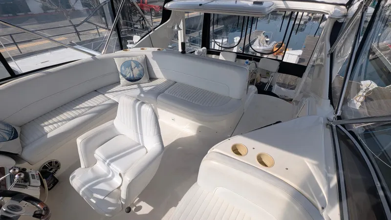 Slide: The Image of 2004 Meridian 408 Motor Yacht interior with white seating and helm station. - 6
