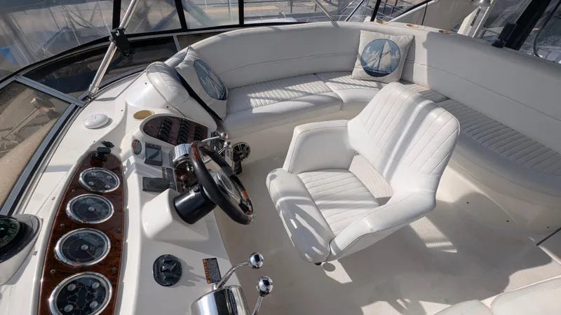 Slide: The Image of 2004 Meridian 408 Motor Yacht cockpit with white seating and control panel. - 7