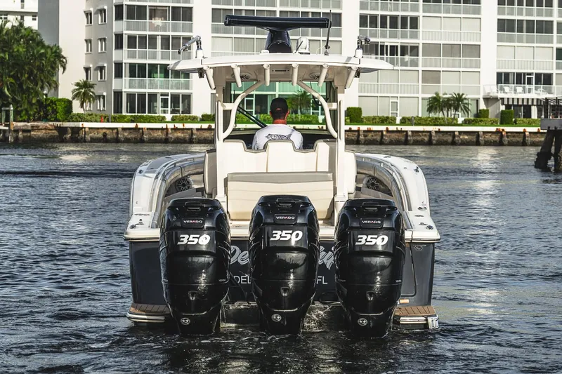 Slide: The Image of 2021 Scout 355 LXF boat with triple 350 horsepower engines on water. - 11