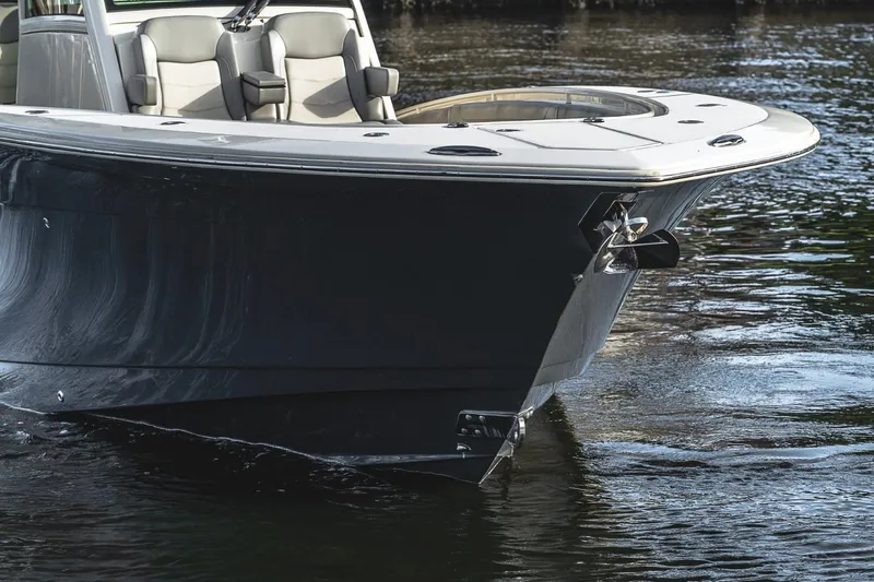 Slide: The Image of 2021 Scout 355 LXF boat on water, showcasing sleek design and luxury seating. - 14