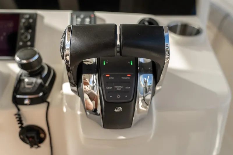 Slide: The Image of Throttle controls on a 2021 Scout 355 LXF boat dashboard. - 26