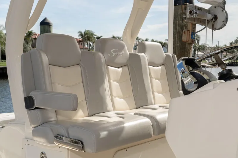 Slide: The Image of Luxurious seating on a 2021 Scout 355 LXF boat, featuring plush, light-colored upholstery. - 32