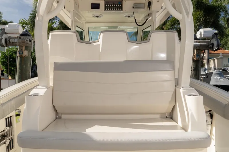 Slide: The Image of 2021 Scout 355 LXF boat interior with white seating and control panel. - 33
