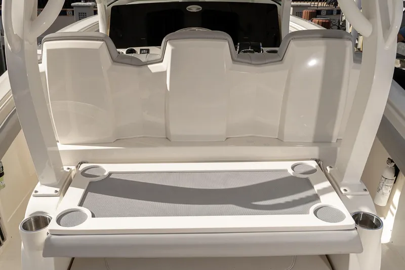 Slide: The Image of 2021 Scout 355 LXF boat seating area with cup holders and sleek design. - 34