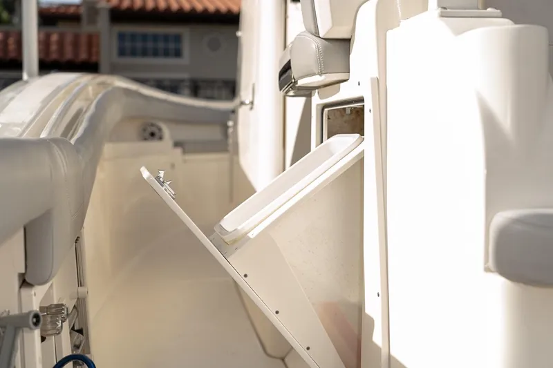 Slide: The Image of 2021 Scout 355 LXF boat interior with open storage compartment. - 38