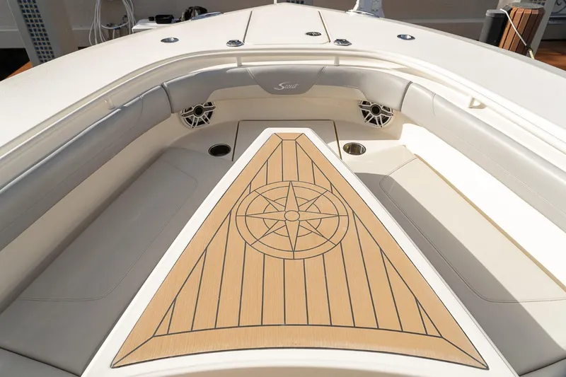 Slide: The Image of 2021 Scout 355 LXF boat interior with compass design on deck. - 41