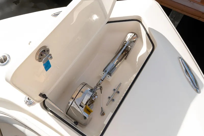 Slide: The Image of Anchor compartment of 2021 Scout 355 LXF boat, open with visible anchor mechanism. - 47