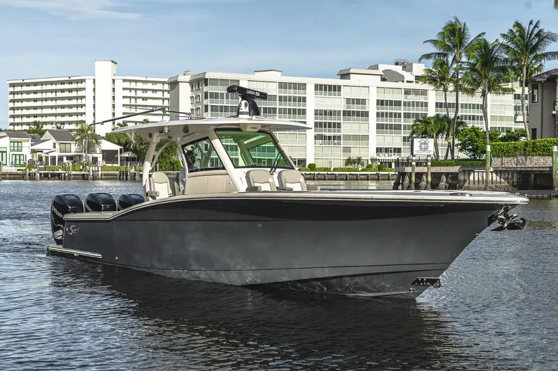 Slide: The Image of 2021 Scout 355 LXF boat on water, modern design, cityscape background. - 5