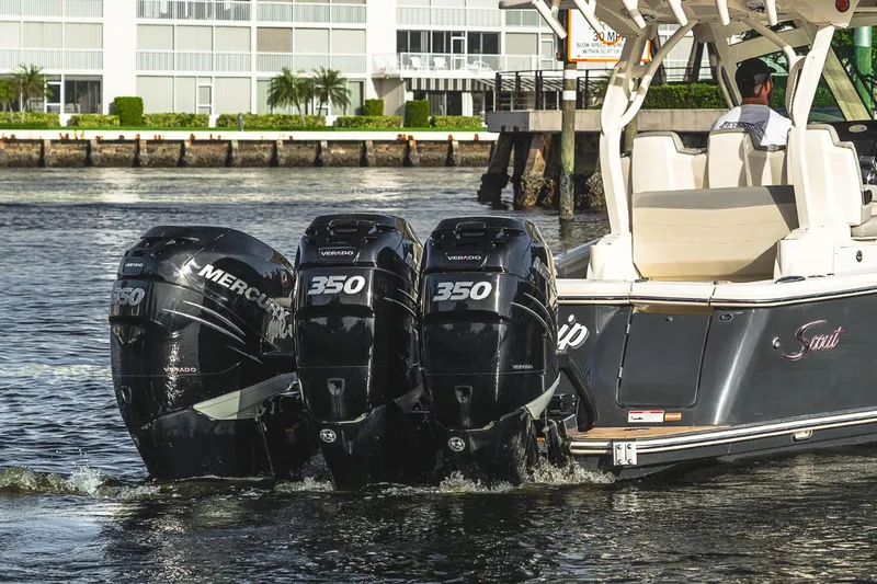 Slide: The Image of 2021 Scout 355 LXF boat with triple Mercury 350 engines on water. - 9