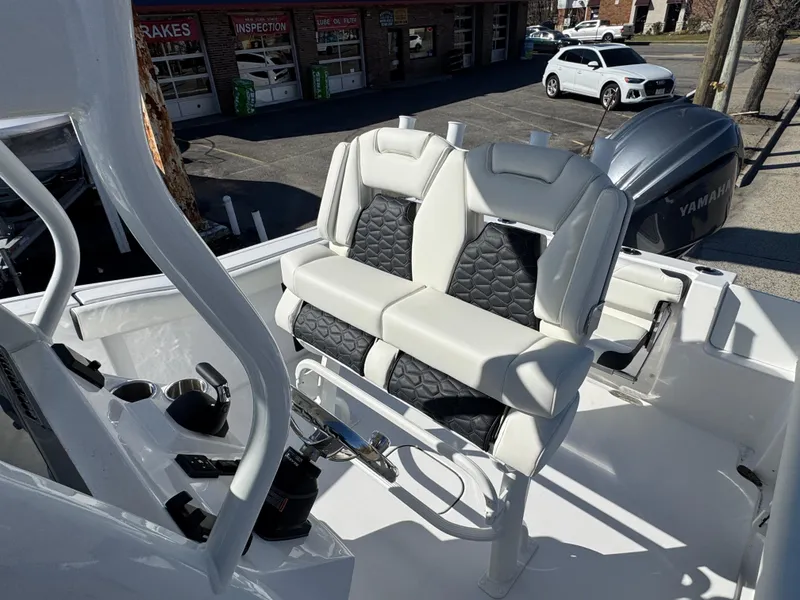 Slide: The Image of 2025 Tidewater 232 CC Adventure boat interior with dual seats and Yamaha engine. - 12