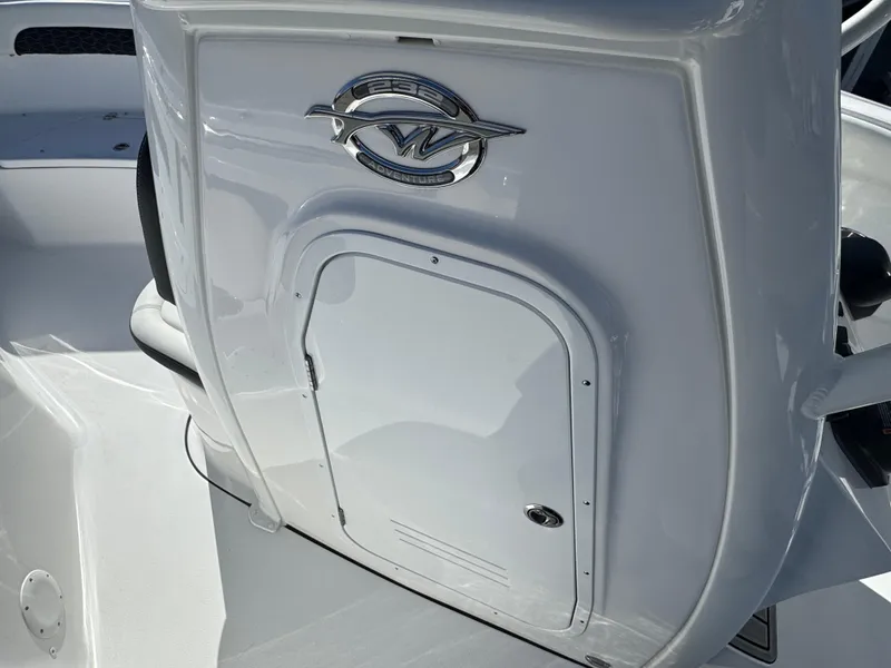 Slide: The Image of 2025 Tidewater 232 CC Adventure boat console with storage compartment and logo. - 15