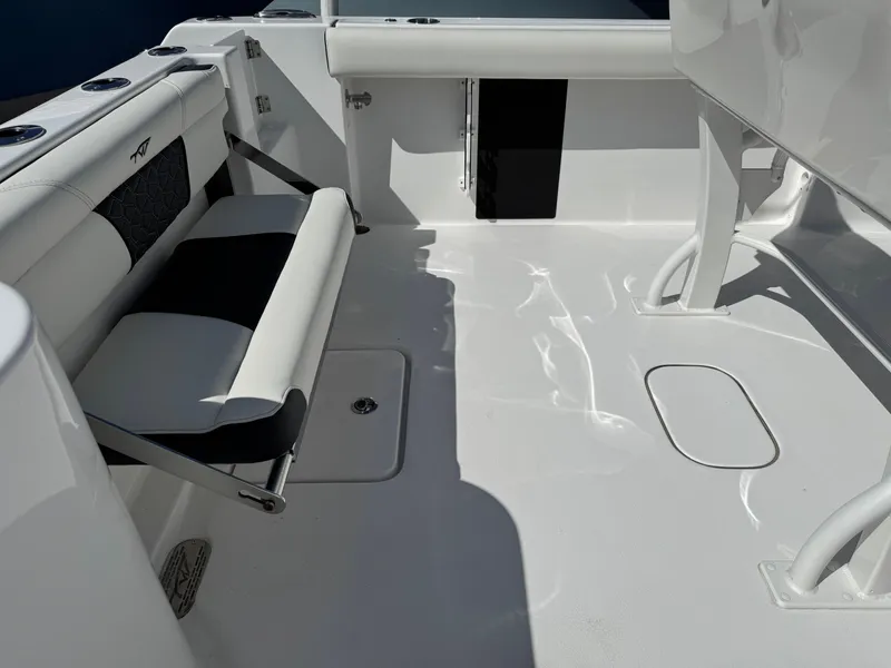 Slide: The Image of 2025 Tidewater 232 CC Adventure boat interior with seating and storage compartments. - 16