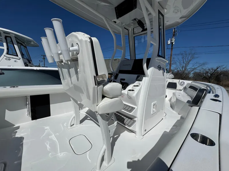 Slide: The Image of 2025 Tidewater 232 CC Adventure boat interior with seating and rod holders. - 17