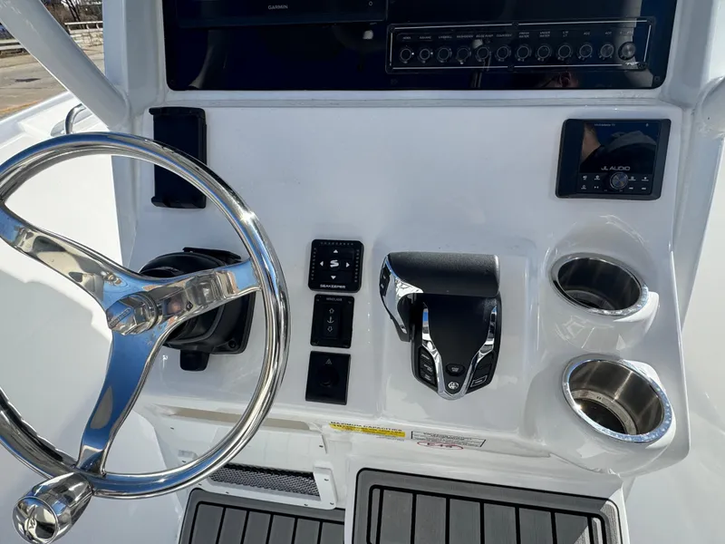 Slide: The Image of 2025 Tidewater 232 CC Adventure boat console with steering wheel and controls. - 6