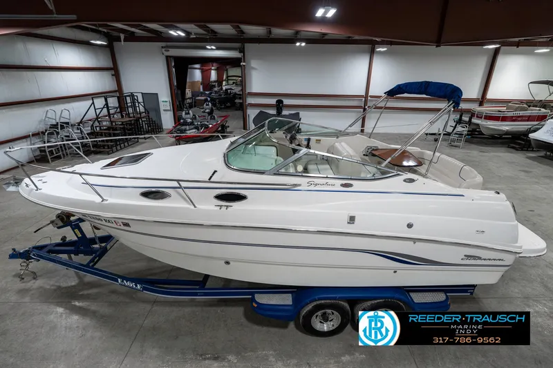 Slide: The Image of 2000 Chaparral Signature 240 boat on trailer in indoor storage facility. - 1