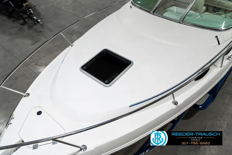 Slide: The Image of 2000 Chaparral Signature 240 boat deck with hatch, displayed indoors. - 11