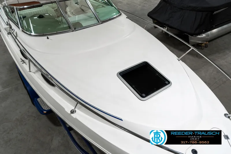 Slide: The Image of 2000 Chaparral Signature 240 boat, white exterior, docked indoors, top view. - 12