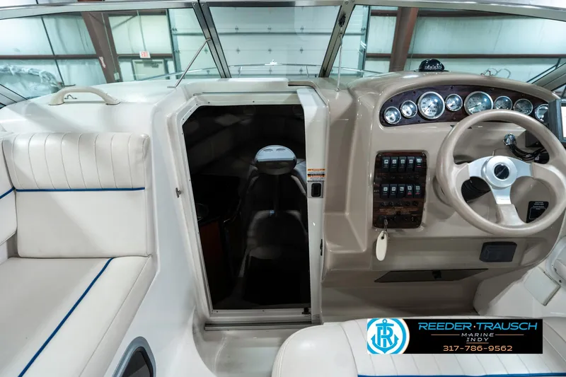 Slide: The Image of 2000 Chaparral Signature 240 boat interior with steering wheel and control panel. - 16