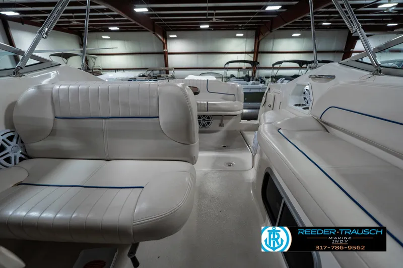 Slide: The Image of Interior of 2000 Chaparral Signature 240 boat with white seating in showroom. - 19