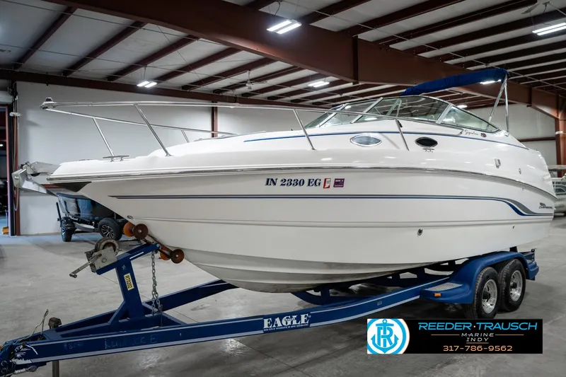 Slide: The Image of 2000 Chaparral Signature 240 boat on trailer in indoor storage facility. - 2