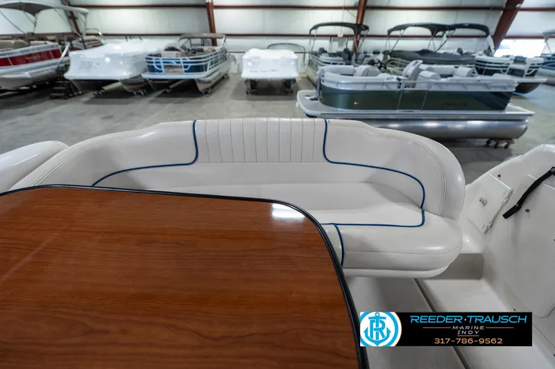 Slide: The Image of Chaparral Signature 240 boat interior with white seating and wooden table, 2000 model. - 20