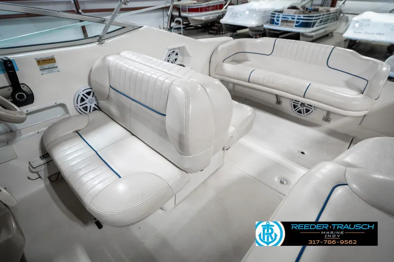 Slide: The Image of 2000 Chaparral Signature 240 boat interior with white seating and blue accents. - 22