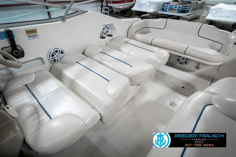 Slide: The Image of 2000 Chaparral Signature 240 boat interior with white seating and blue accents. - 23