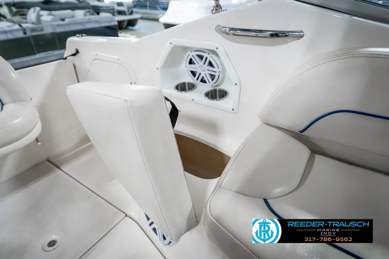 Slide: The Image of 2000 Chaparral Signature 240 boat interior with white seating and cup holders. - 25