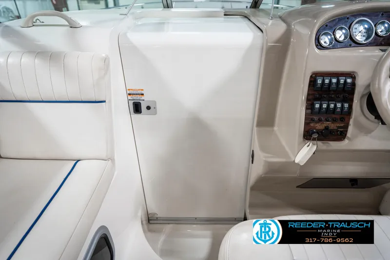 Slide: The Image of 2000 Chaparral Signature 240 boat interior with dashboard and seating area. - 26