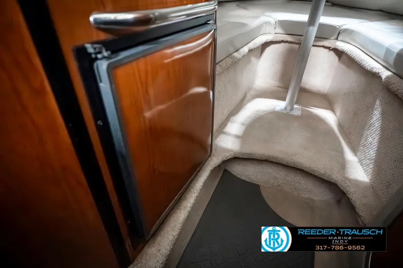 Slide: The Image of 2000 Chaparral Signature 240 cabin interior with wood cabinetry and cozy seating area. - 28