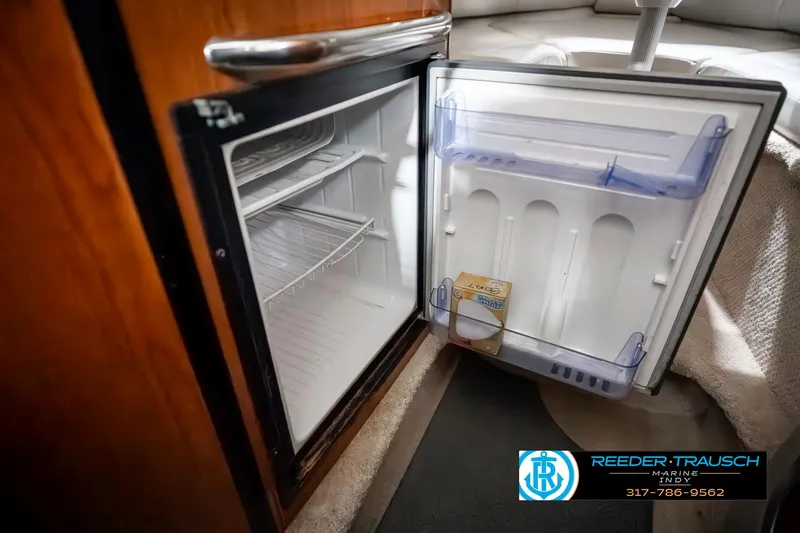 Slide: The Image of Open mini fridge inside 2000 Chaparral Signature 240 boat cabin. - 29