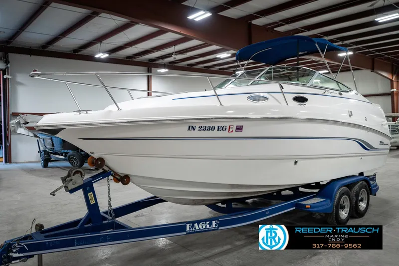 Slide: The Image of 2000 Chaparral Signature 240 boat on trailer in indoor storage facility. - 3