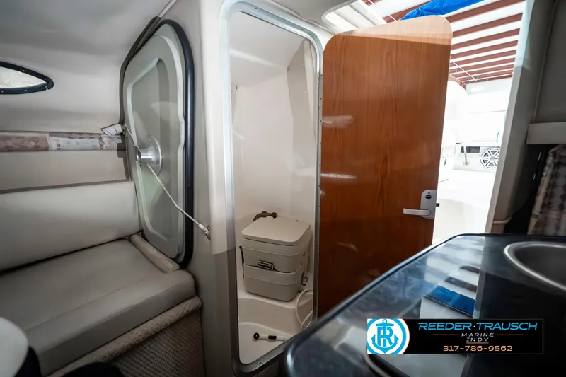 Slide: The Image of 2000 Chaparral Signature 240 cabin interior with compact bathroom and seating area. - 36