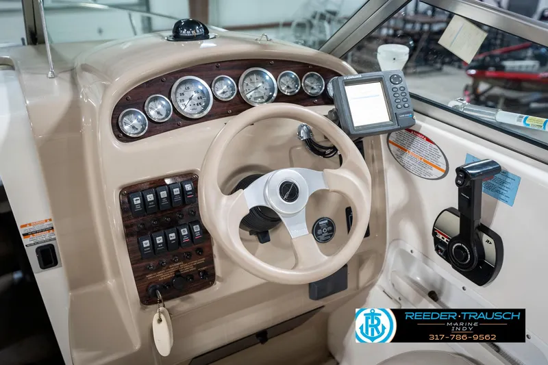 Slide: The Image of 2000 Chaparral Signature 240 boat dashboard with steering wheel and navigation instruments. - 37