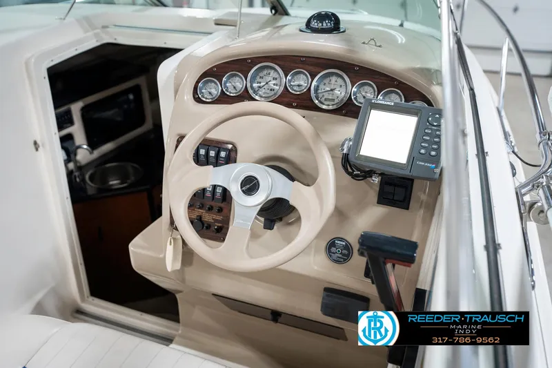 Slide: The Image of 2000 Chaparral Signature 240 boat dashboard with steering wheel and navigation instruments. - 38