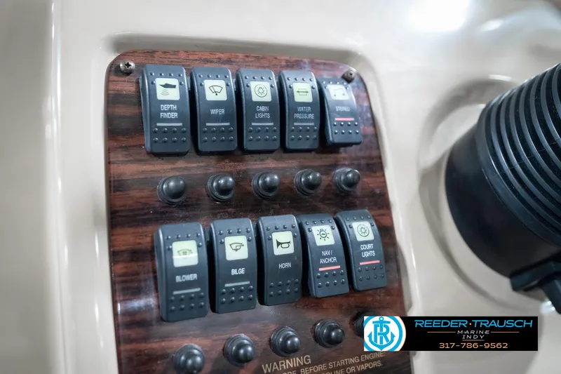 Slide: The Image of Control panel of a 2000 Chaparral Signature 240 boat with labeled switches. - 40
