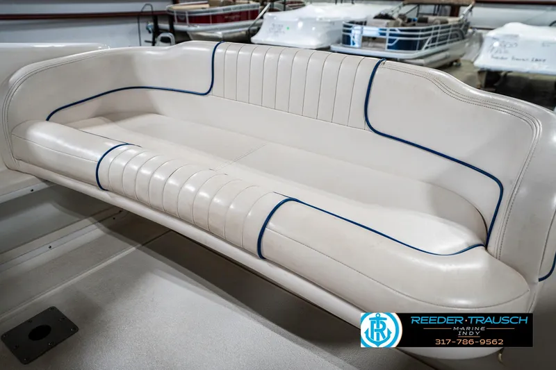 Slide: The Image of 2000 Chaparral Signature 240 boat interior with white and blue cushioned seating. - 48