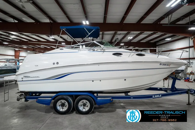 Slide: The Image of Chaparral Signature 240 boat, 2000 model, on a trailer in a warehouse setting. - 6