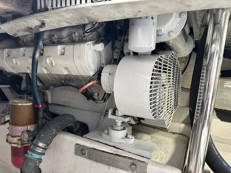 Slide: The Image of Engine compartment of a 2000 Cabo Convertible boat, showcasing mechanical components and wiring. - 26