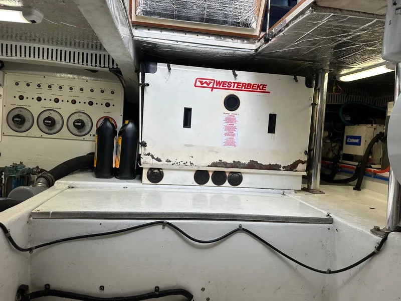 Slide: The Image of Engine room of a 2000 Cabo Convertible with Westerbeke generator and control panel. - 28