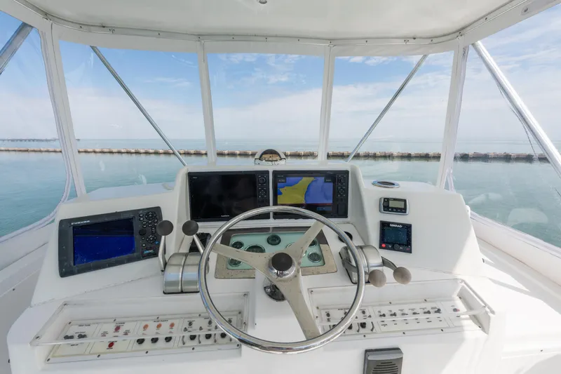 Slide: The Image of Cabo Convertible 2000 boat helm with navigation equipment and ocean view. - 8