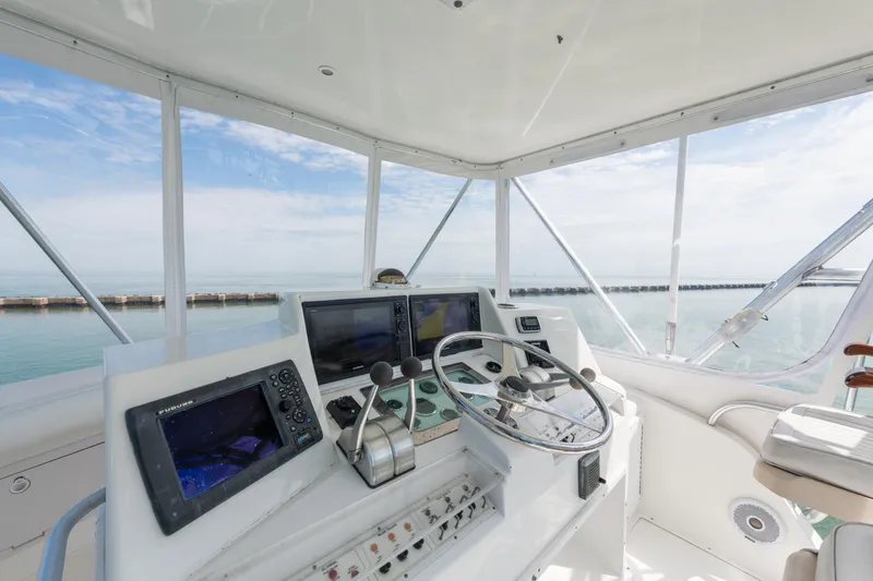 Slide: The Image of Helm of 2000 Cabo Convertible boat with navigation equipment and ocean view. - 9