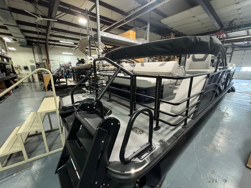 Slide: The Image of 2025 Sylvan L3 CLZ pontoon boat in a showroom, showcasing sleek design and modern features. - 11
