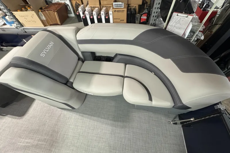 Slide: The Image of 2025 Sylvan L3 CLZ boat seating with gray and black upholstery in showroom. - 4