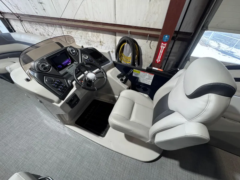 Slide: The Image of 2025 Sylvan L3 CLZ boat interior with modern steering console and comfortable seating. - 5
